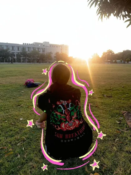 Sun breathing. A photo of me in a Demon Slayer t-shirt during golden hour, with doodles to match the anime theme.