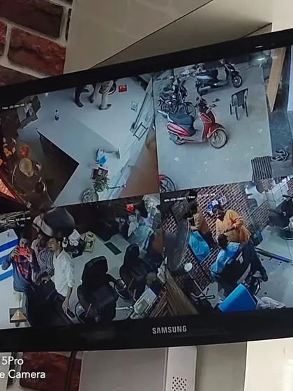 A multi-camera view inside a salon or barbershop, covering the work stations and waiting area.
