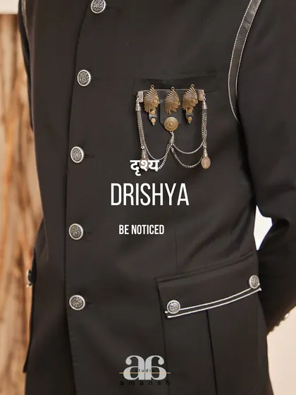 "Be Noticed." This image captures the essence of our brand, focusing on the unique metallic embellishment of our black bandhgala, a detail designed for the man who wants his style to speak for itself.
