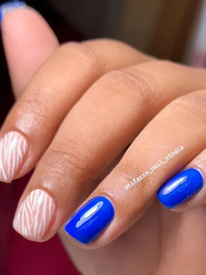 Go bold with this striking combination of electric blue and white zebra stripes. This design is perfect for clients who want a fun, high-contrast look. We teach you how to paint crisp, clean animal prints.