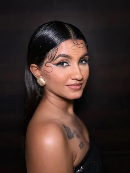 A three-quarter view of the airbrush look, highlighting the sleek hairstyle and the way the graphic liner accentuates the eye shape.