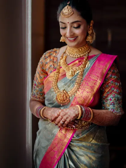 A smiling portrait of the bride, her happiness shining through. The makeup is classic and elegant, perfect for her Muhurtham ceremony.