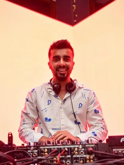 A bright, happy photo of me at the decks. This shot radiates positivity and the pure joy I find in playing music.