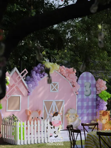 Another view of the main stage area, showing how the different elements come together. The pastel barn, balloon garlands, and character cutouts create a cohesive and visually delightful scene for a child's birthday.