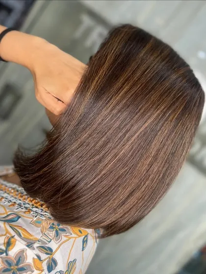 A close-up of the sleek caramel bob, highlighting the flawless color and shine.