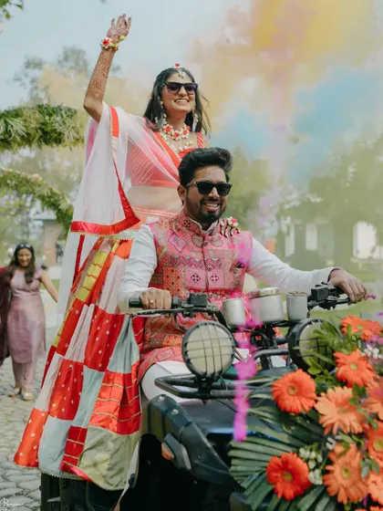Making a grand entrance on an ATV. This fun and unique shot from their Haldi ceremony perfectly captures the couple's adventurous and playful spirit.