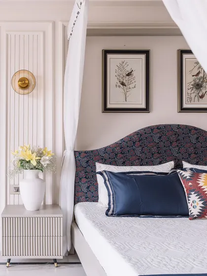 Another beautiful angle of the 'Modern Muse' bedroom, focusing on the custom headboard, the elegant wall sconce, and the fluted bedside table, all contributing to a sophisticated design.