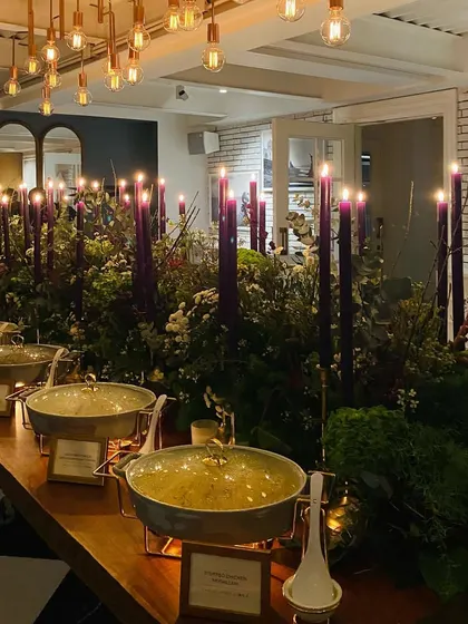 Another view of the purple-themed buffet, showing our stylish serveware and the warm lighting from the Edison bulbs above.
