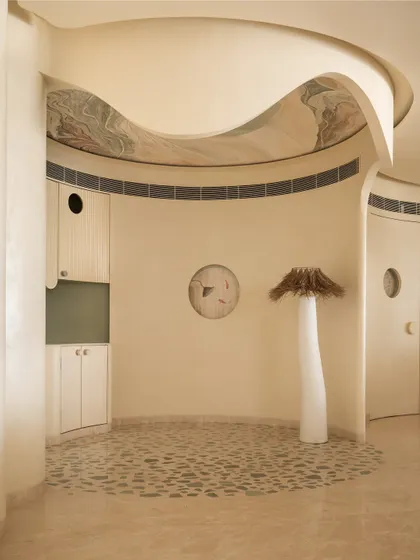 Another view of the coffee corner, showing the curved walls and the unique, artistic details that make the space special.