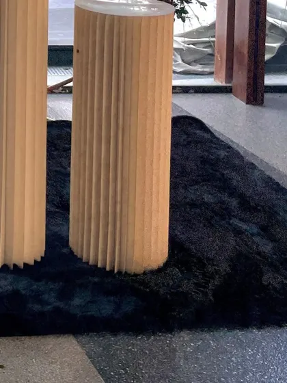 A detail shot of the fluted plinths and the soft black rug used to ground the decor space for the send-off party.