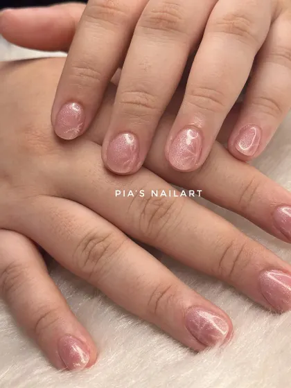 This is an acrylic overlay on natural nails, topped with a cat eye effect. An overlay adds strength to your own nails, helping them grow long and strong without breaking.