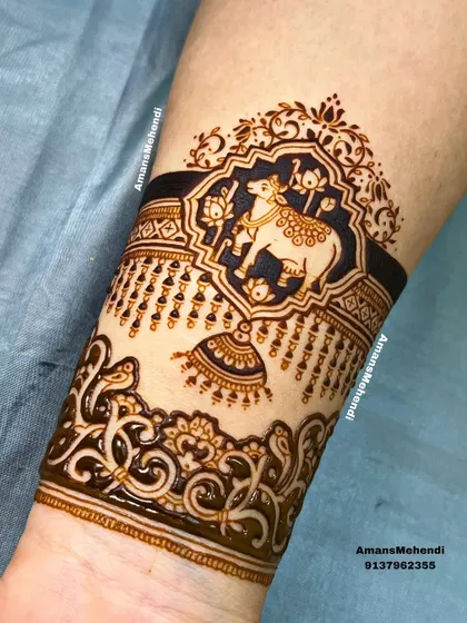 A beautiful arm band featuring a sacred cow (Kamdhenu) in a decorative frame. The hanging bell and intricate border add to the divine feel of the design.