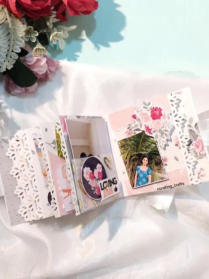 An inside page of the mini scrapbook from the wooden box set, featuring delicate lace-like details.