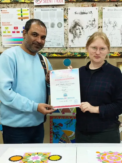 Another international student receiving her certificate of participation. Our workshops are a great way for visitors to experience Indian culture firsthand.