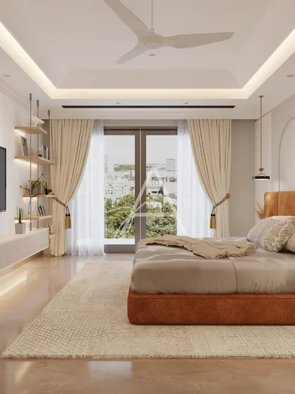 Large windows allow natural light to flood this bedroom, offering a view of the city. The layout is designed to take full advantage of the light and view, creating a bright and airy space.