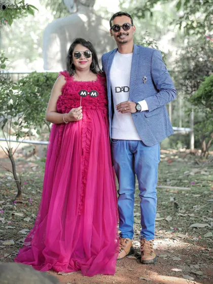 This couple shows off their cool and fun side with sunglasses and "MOM" and "DAD" props. It's a great way to show your personality as parents-to-be.