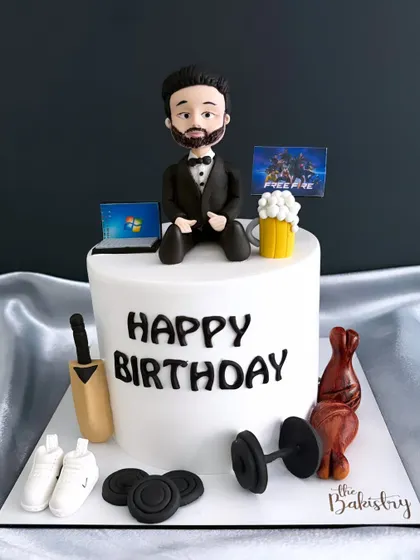 Another angle of the personalized hobbies cake, showing all the unique, handcrafted toppers.