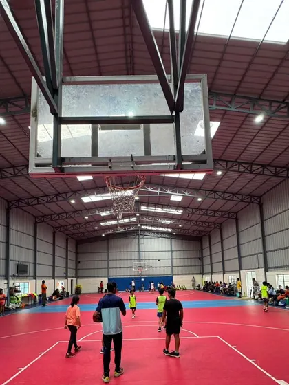 A view from under the basket, showing the scale and professional setup of our indoor basketball facility.