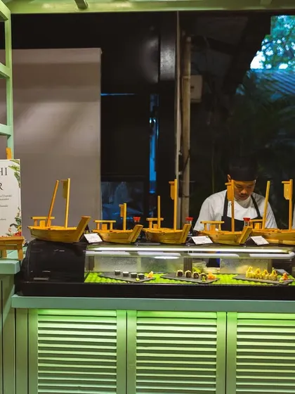 Our full Sushi Bar setup, complete with decorative boats and chefs ready to roll.