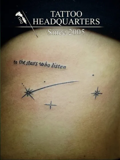 A shooting star tattoo with the quote "to the stars who listen," a magical and literary-inspired piece.