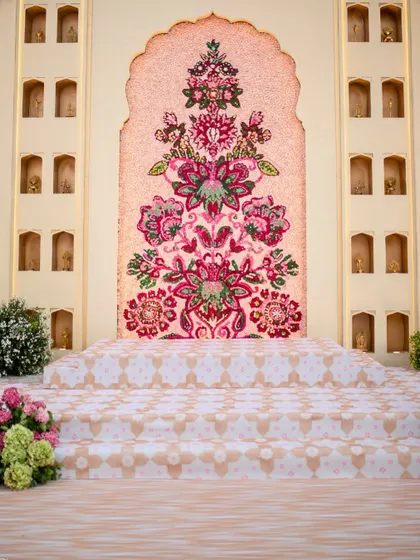 The stunning floral mosaic wall we created for a Jaimala ceremony. This backdrop, made entirely of fresh flowers, served as a piece of living art for the couple's first official moment as husband and wife.