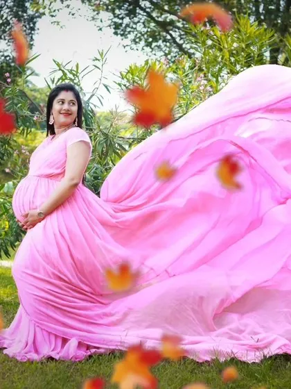 The flowing fabric of this pink gown creates a sense of movement and magic, perfect for capturing whimsical maternity photos.