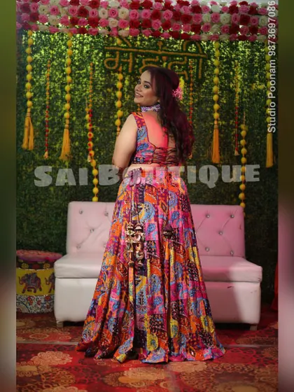 The bride looks stunning at her Mehndi ceremony in this multi-colored patchwork lehenga. The backless blouse with criss-cross detailing adds a modern touch.