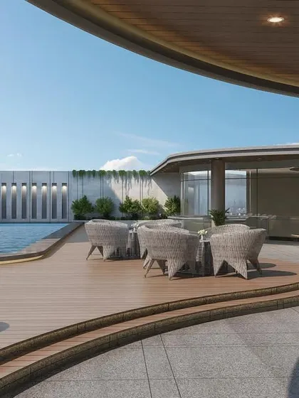 This view highlights the integration of the pool with the flowing design of the rooftop deck. The layout creates multiple zones for lounging and socializing, all unified by the sleek, wave-inspired architectural language.