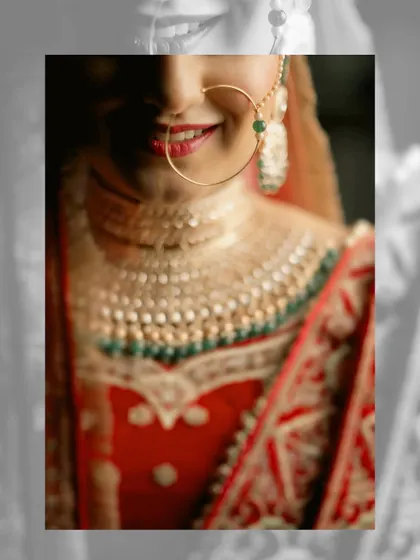 An artistic close-up of a bride's smile and traditional nath. The shallow depth of field creates a beautiful, soft-focus effect that draws attention to her joy.