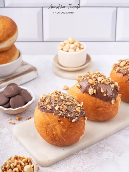 Nutella-filled bombolonis, looking soft and delicious in a bright, clean setting.