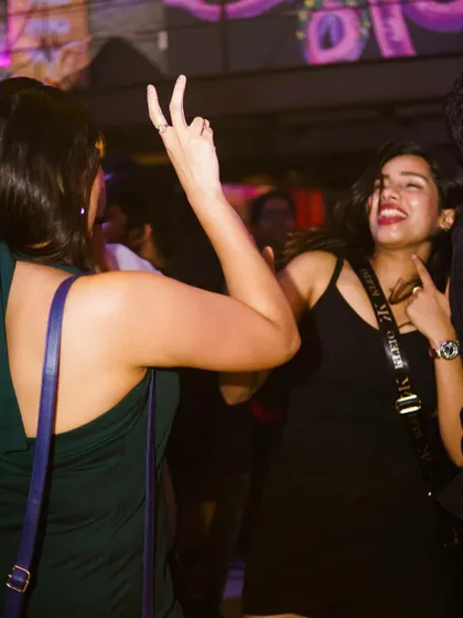 It's all about the good times and great music. Two friends enjoying the vibe and making memories on the dance floor.