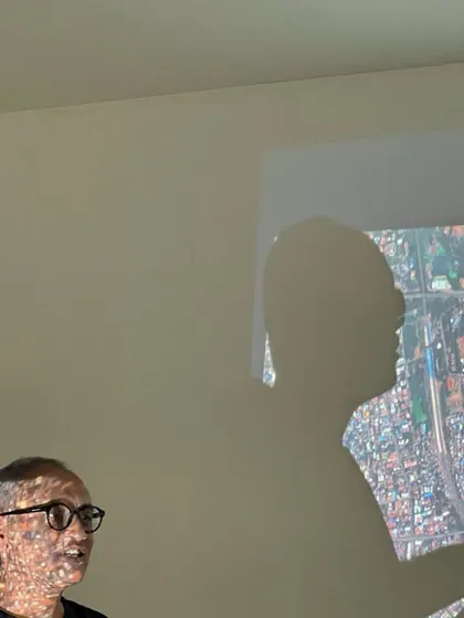 My shadow cast over a projection of an urban site map during a lecture. This image speaks to the way an architect's vision is literally and figuratively projected onto the city.