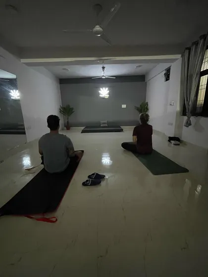 A view of my evening batch, where students are seated in a meditative posture to begin or end their practice. The dim lighting helps in turning the focus inward.