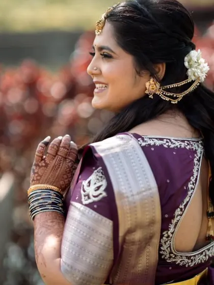 A happy, candid moment from Shanvi's engagement. The back of the blouse features delicate embroidery that complements her hairstyle.
