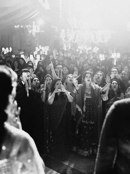 The loudest cheers always come from the ones you love. This shot captures the energy of the crowd, a testament to a truly great party.