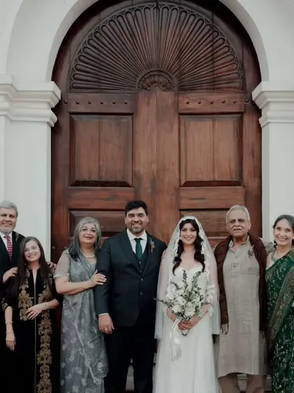 A beautiful family portrait. The bride's classic hair and makeup style ensures she looks timeless and elegant in photos that will be cherished for years.