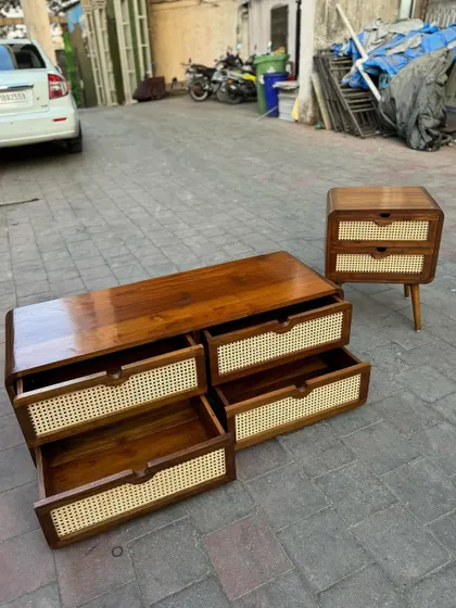 The same chest of drawers with the drawers open to show their depth and smooth operation. It is shown next to a matching two-drawer nightstand.