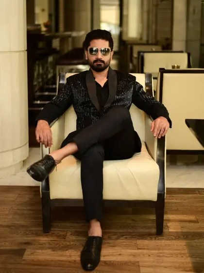 A client exuding confidence in our black sequin blazer. This is modern menswear at its finest.