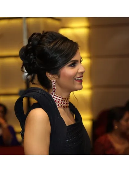 A candid shot of Priyanka enjoying her event. The makeup is designed to look great both in posed portraits and in spontaneous moments like this.