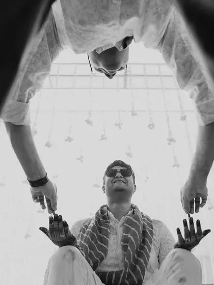 A creative, low-angle black and white shot of the groom during his Haldi. I'm always looking for unique perspectives to make your photos stand out.