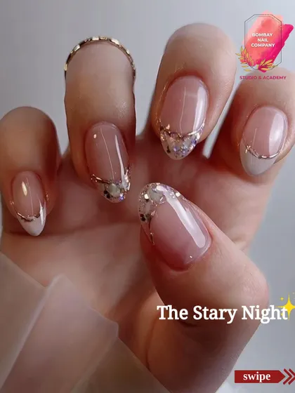 We call this one 'The Starry Night'. It's an elegant design featuring a modern French tip with a delicate line of crushed crystals and a fine gold wire accent.