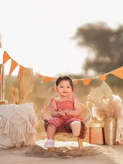 An outdoor boho-themed shoot for a toddler. I can set up beautiful, stylized scenes in natural settings, complete with props like a teepee and macrame details.