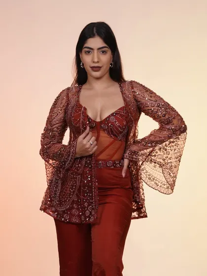 Another view of the rust-colored corset set. The combination of the structured corset and the flowing jacket is a perfect balance.