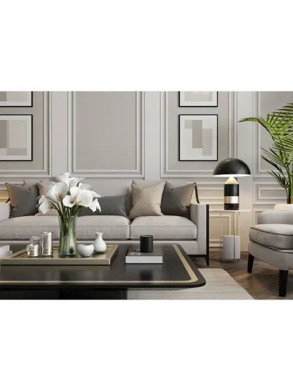 A close-up of a well-styled living room. The elegant sofa, modern floor lamp, and curated decor on the coffee table show our attention to the final touches that make a house a home.
