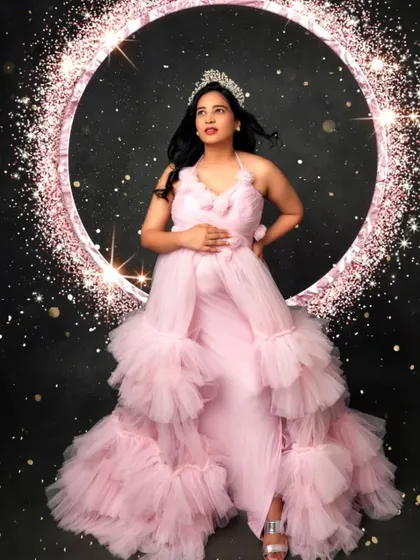 Feel like a princess in this pink ruffled gown, complete with a sparkling tiara and a glamorous, starry backdrop.
