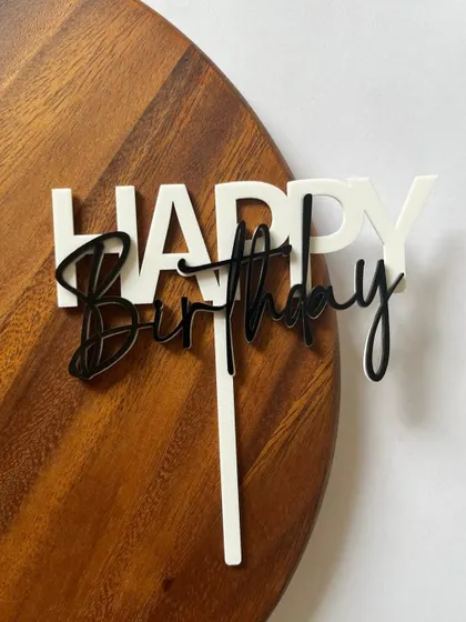 A clean and modern "Happy Birthday" topper in layered white and black acrylic. The contrasting fonts make for a dynamic and eye-catching design.