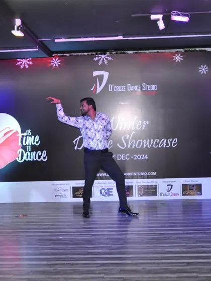 A wide shot of a solo performer commanding the stage at our Winter Dance Showcase.