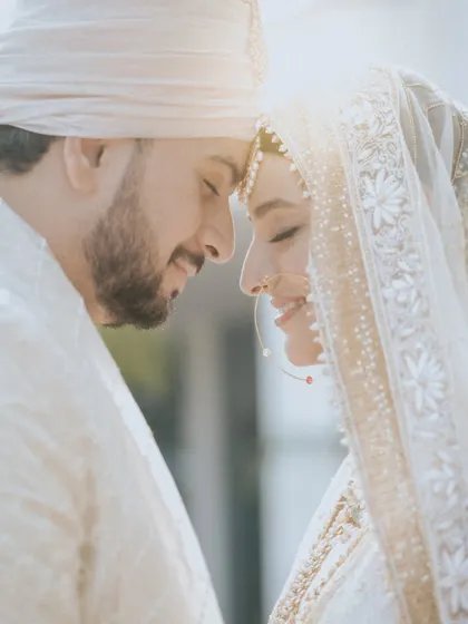 A classic "nuzzle" pose that radiates warmth and affection. The soft, bright lighting and the couple's gentle smiles make this a purely romantic and timeless portrait.