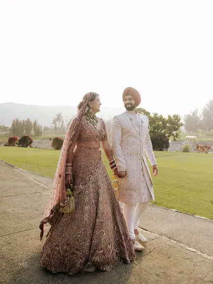 A romantic outdoor portrait of a Sikh couple. The soft, natural light and the gentle embrace create a feeling of warmth and intimacy.