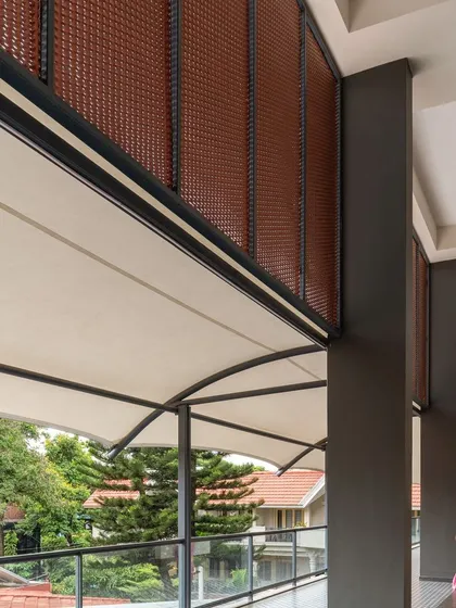 A corridor in the Koramangala Club Annexe that is not burdened by function, but serves as a space for transition and connection. The interplay of the tensile roof, cane screens, and views of the landscape creates a rich sensory experience.